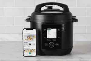 CHEF iQ Smart Pressure Cooker with smartphone app on modern kitchen countertop