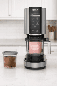 Ninja NC301 CREAMi ice cream maker on modern kitchen counter with frozen desserts