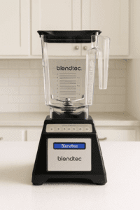 Blendtec Total Classic blender on a white kitchen countertop with clear container