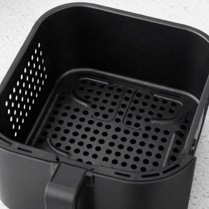 Non-stick air fryer basket from Instant Pot Vortex Plus XL 8QT showing perforated airflow base for even crisping