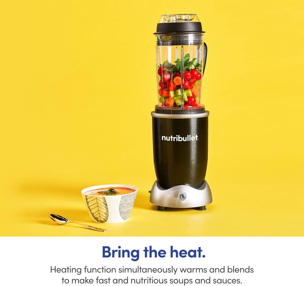 NutriBullet RX blender with fresh vegetables and a bowl of hot soup on a yellow background, highlighting its heating function.