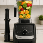 Vitamix Ascent X3 blender with tamper and container filled with fruits and greens