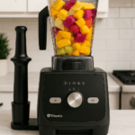Vitamix Ascent X5 blender on kitchen countertop with fruit-filled container and tamper